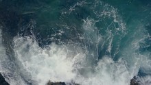 Breaking Ocean Waves At The Cliffs. Waves Crashing The Rocks. Aerial View 4K UHD.