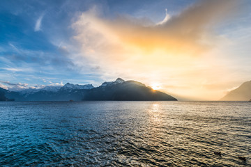 Wall Mural - The sunset is burning. Bright fantastic sunset over the Alpine ridge and Lake Lucerne.