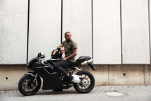 Portrait Of A Young Afro American Man On A Motorcycle