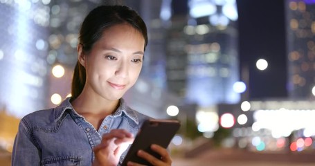 Canvas Print - Woman use of mobile phone in the city at night