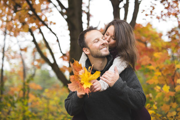 Young couple in love in a park on a autumn day