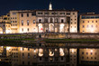View of the reflected buildings and Florence Rowing Club in the river Arno.