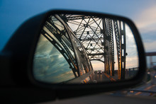 Car Mirror Reflection With View On Bridge