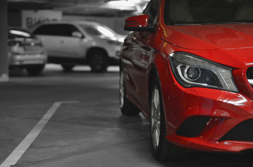 half of parked car on underground parking