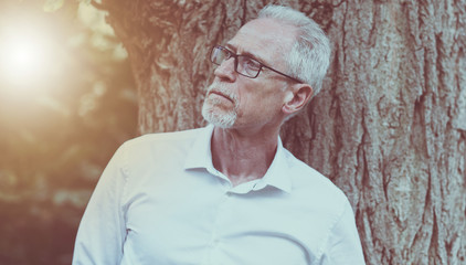 Portrait of thoughtful mature man, light effect