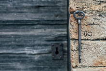 Grunge Wooden Door With Rusty Keyhole And Key