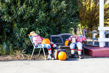 Two Halloween Scarecrows Relasing With Pumpkins & Suitcases