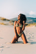 © DavidPrado - Beautiful young woman posing on the sand in the beach
