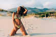 © DavidPrado - Beautiful young woman posing on the sand in the beach