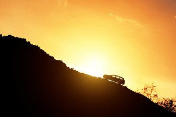 Toy car drive uphill and light of sunrise. Concept effort