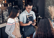 © weedezign - Asia Barista waiter take order from customer in coffee shop,Two cafe owner writing drink order at counter bar,Food and drink business concept,Service mind concept.
