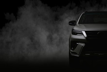 Studio Shot Of White Car Isolated On Black Background With Shadow And Smoke Fog.