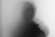 © bubbers - Shadow blur of horror man screaming mask.Dangerous man behind the frosted glass.Mystery man.Black and white picture.Blur picture.Add effects noise and grain.Halloween.