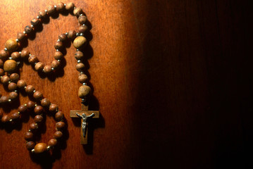 wooden rosary on th eold wooden table