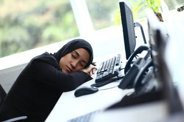 Beautiful muslim lady sleeping at her desk