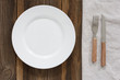 © knlml - Empty Plate And Cutlery On The Wooden Table