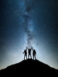 © biletskiyevgeniy - Silhouettes of team on mountain peak. Sport and active life concept on the night sky background.