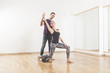 © Tommaso Lizzul - Pilates instructor coaching a beautiful woman using foam roller