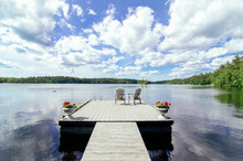 Dock On A Lake With Chairs And Loon
