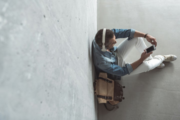 Wall Mural - Cute pleasant guy is listening to music