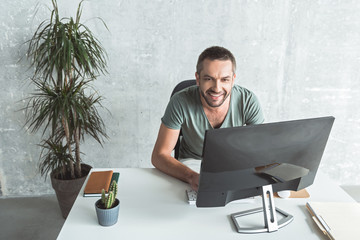 Wall Mural - Cheerful young guy is laboring with pleasure