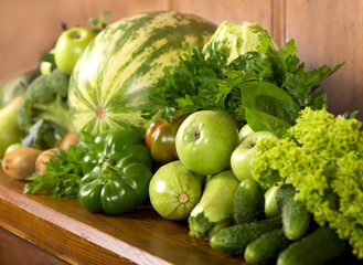 Wall Mural - Green vegetables a wooden background