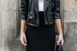 © BONNINSTUDIO/Stocksy - Closeup of woman wearing leather jacket and long black skirt in front a urban wall.