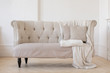 © demphoto - Horizontal indoors shot of light interior with small couch.