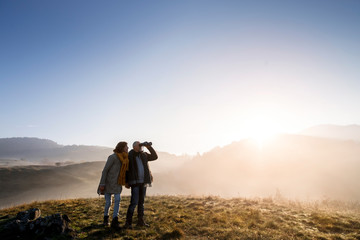 Wall Mural - Senior couple on a walk in an autumn nature.