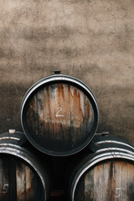 Close Up Of Three Wine Barrels And A Concrete Wall
