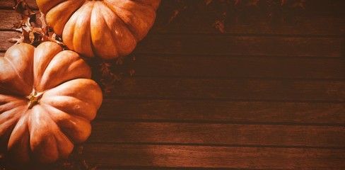 Canvas Print - Orange pumpkins with autumn leaves on table