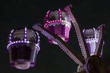 Small Ferris Wheel Fairground Ride Illuminated Against A Black Sky