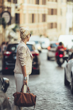 Elegant Blonde Businesswoman Crossing The Street