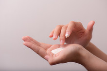 Close Up Of Women Hands Receiving Sunblock Cream Lotion