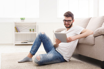 Young man at home messaging online