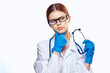 © SHOTPRIME STUDIO - woman medical officer in uniform and glasses pondered over stethoscope