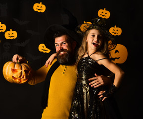 Father and daughter in costumes. Wizard and little witch