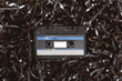 © Marcel/Stocksy - Old audio cassette on a bed of loose tape