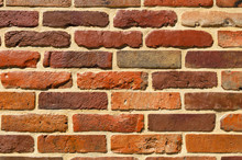 The Wall Is Composed Of Bricks Painted Brown And Orange Paint