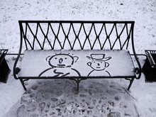 Two Characters Drawn On A Snowy Bench