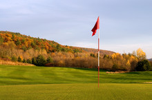 Golf Green And Pin In The Colored Autumn Mountains