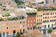 Cityscape with elevated view of city and commercial and residential buildings with tile rooftops in Rome, Italy
