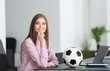 © Africa Studio - Young beautiful woman with soccer ball in office