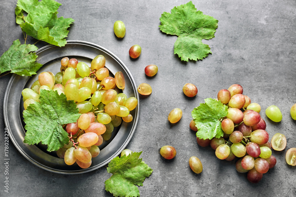 Fresh ripe grapes on textured background