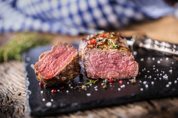 Wall Mural - Beef Steak. Roasted Beef steak with salt pepper thyme on rustic wooden table