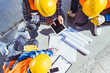© LIGHTFIELD STUDIOS - construction workers discussing building plans