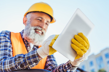 Wall Mural - construction worker using digital tablet