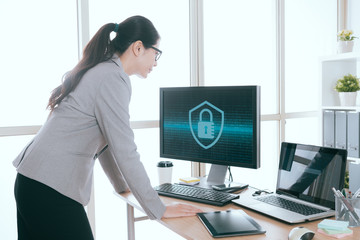 Wall Mural - woman standing in front of working computer