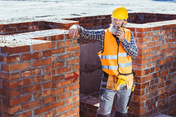 Wall Mural - Construction worker talking on portable radio