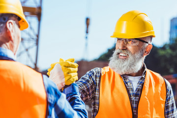 Wall Mural - construction workers shaking hands